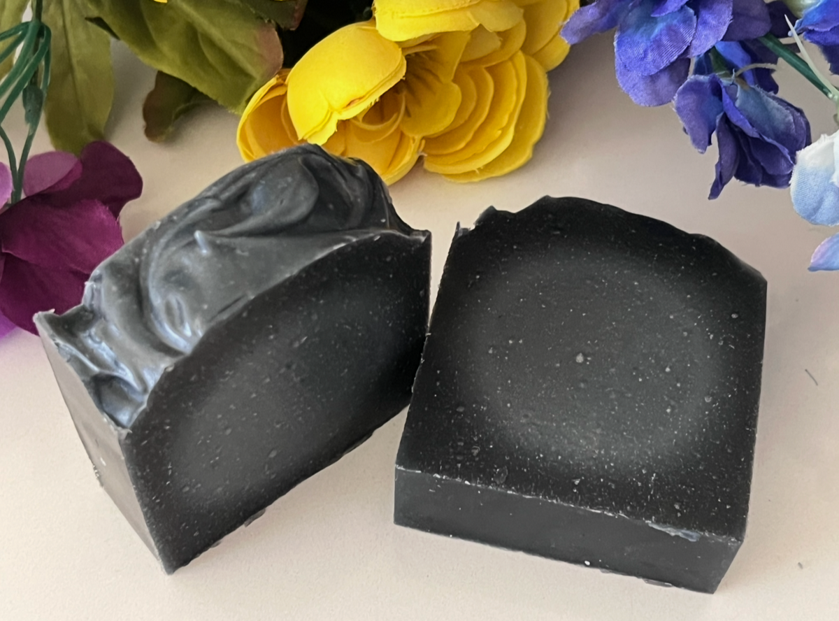 Two bars of handcrafted tallow and activated charcoal facial soap